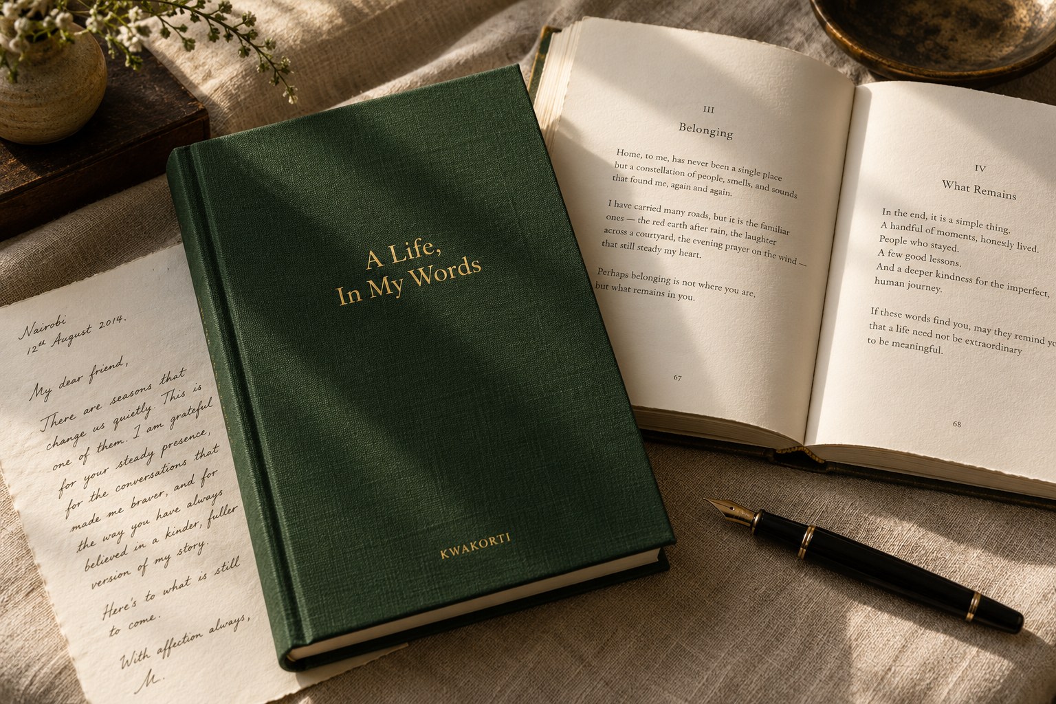 Illustrative green clothbound book beside an open book, a handwritten letter and fountain pen